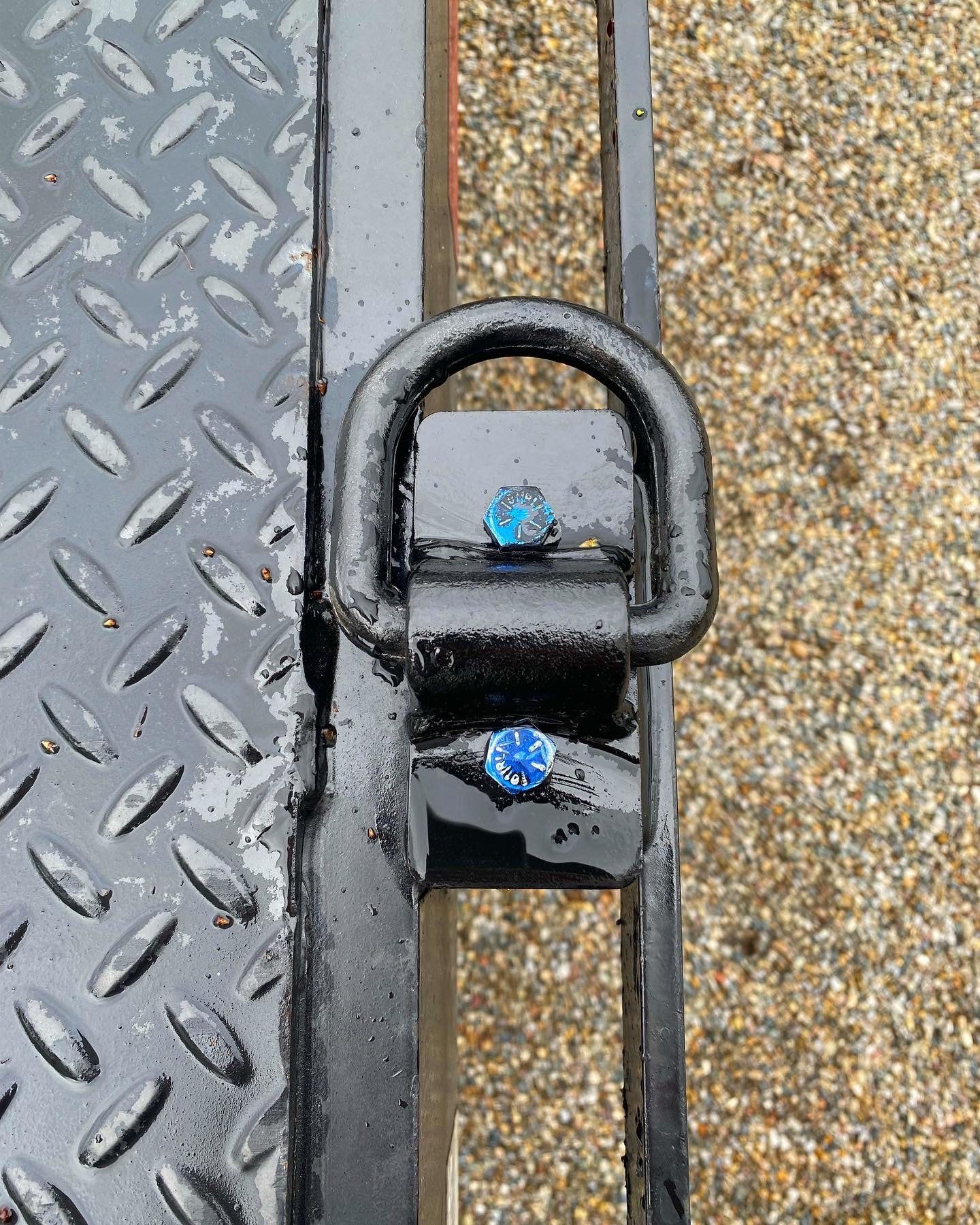 Trailer stake pocket tie down