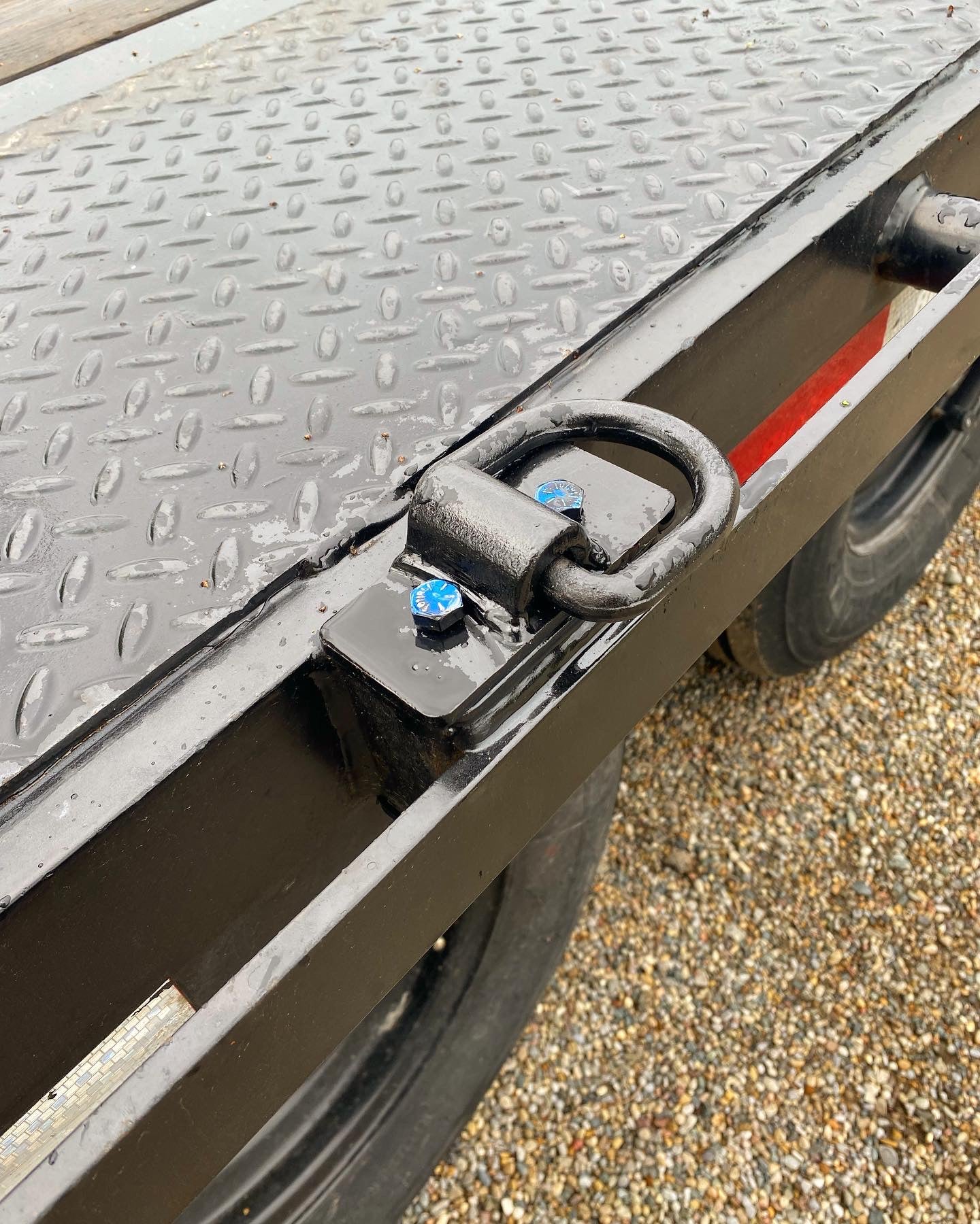 Trailer stake pocket tie down